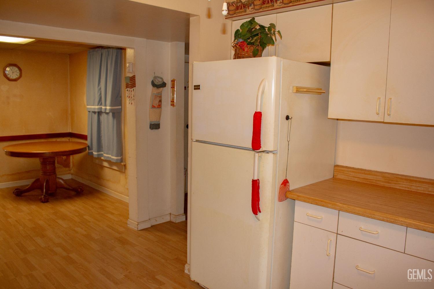 Undisclosed Address Bakersfield, CA 93307 - Photo 18 of 29 a white refrigerator freezer sitting inside of a kitchen