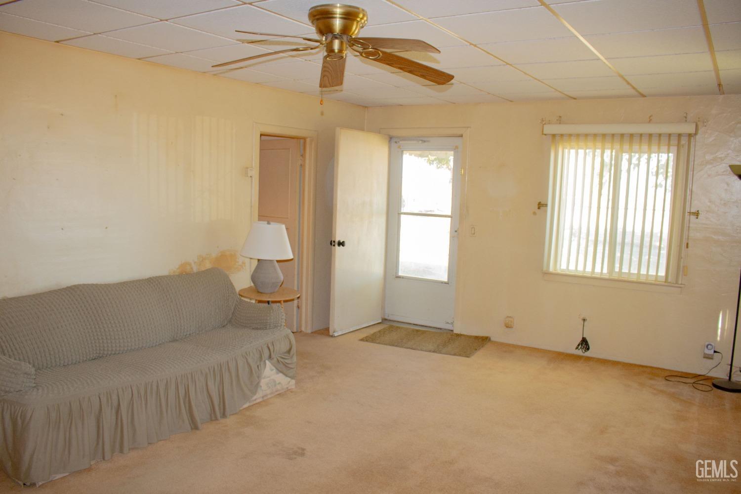Undisclosed Address Bakersfield, CA 93307 - Photo 4 of 29 a living room with furniture and a window
