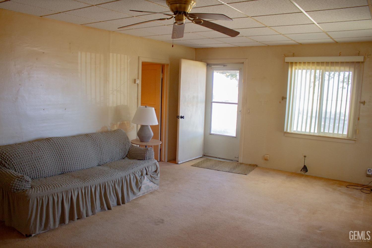 Undisclosed Address Bakersfield, CA 93307 - Photo 5 of 29 a living room with furniture and a chandelier