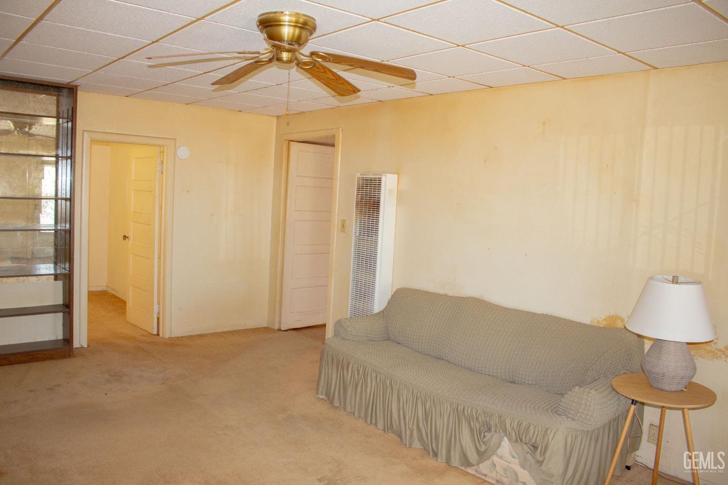 Undisclosed Address Bakersfield, CA 93307 - Photo 6 of 29 a living room with a couch and a chandelier