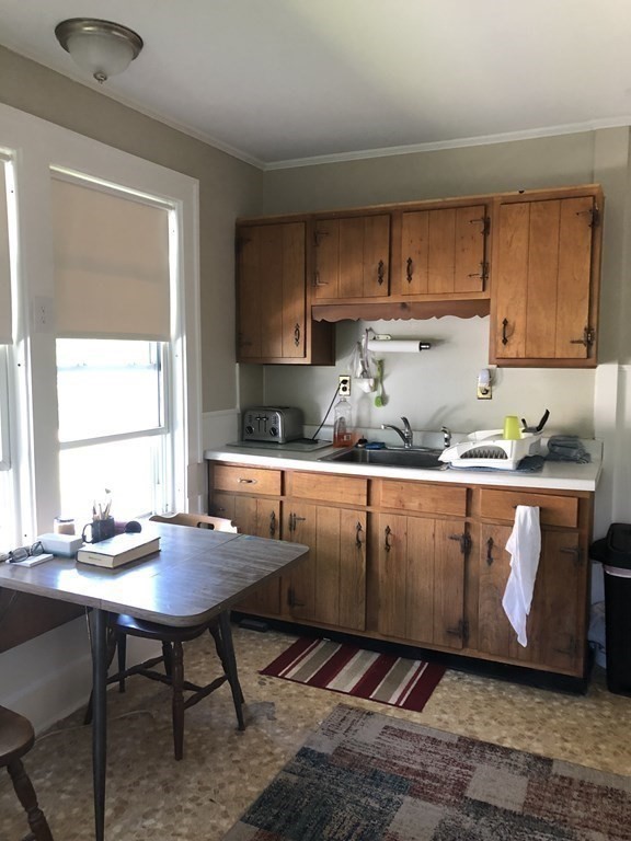 10 Worcester Avenue Montague, MA 01376 - Photo 5 of 35 a kitchen with granite countertop a table chairs sink and cabinets