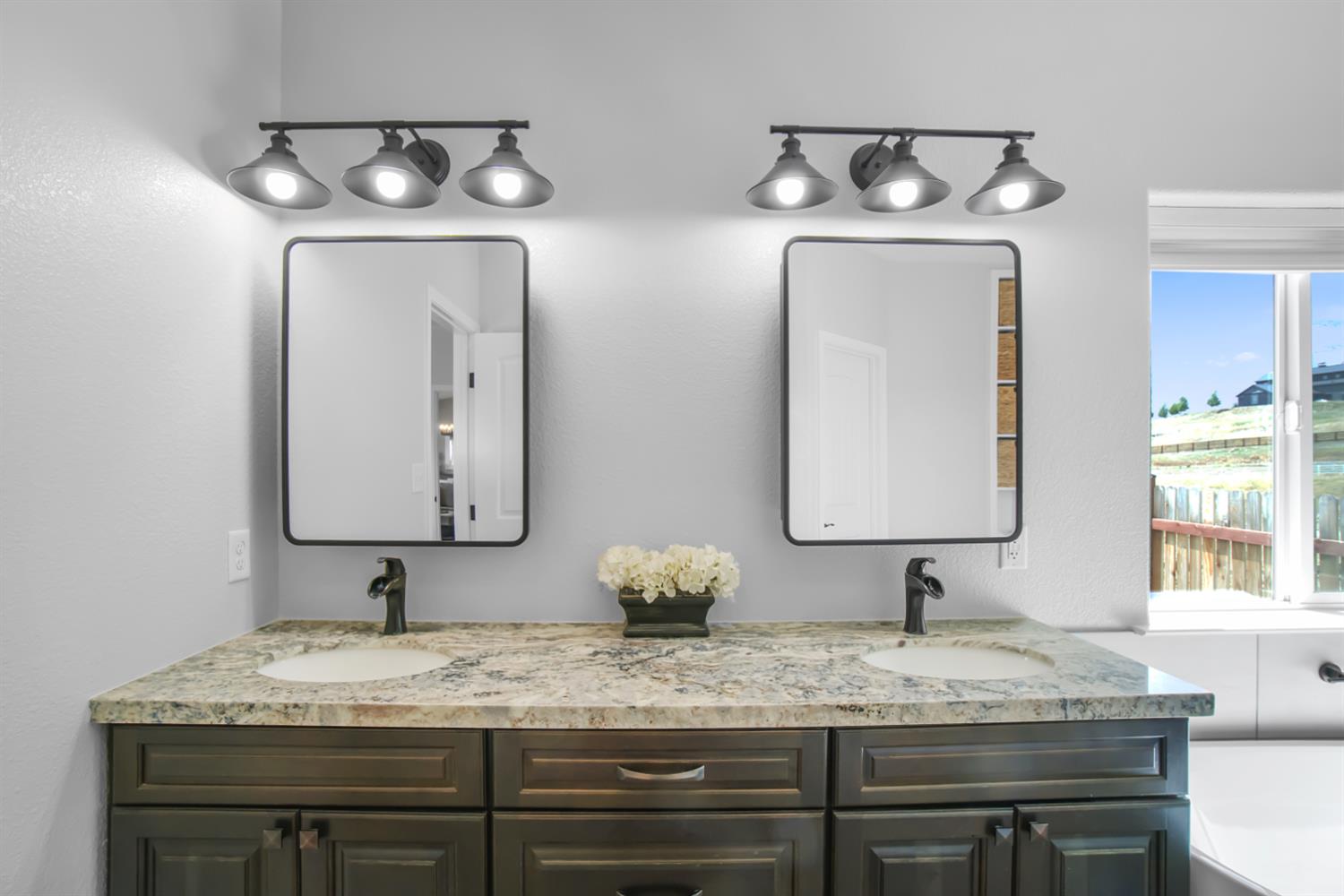 7991 South Shingle Road Shingle Springs, CA 95682 - Photo 24 of 58 a bathroom with double vanity sinks and a mirror