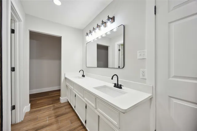 a bathroom with a double vanity sink and a mirror