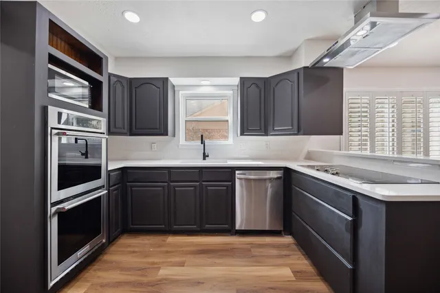 a kitchen with stainless steel appliances granite countertop a refrigerator and a sink