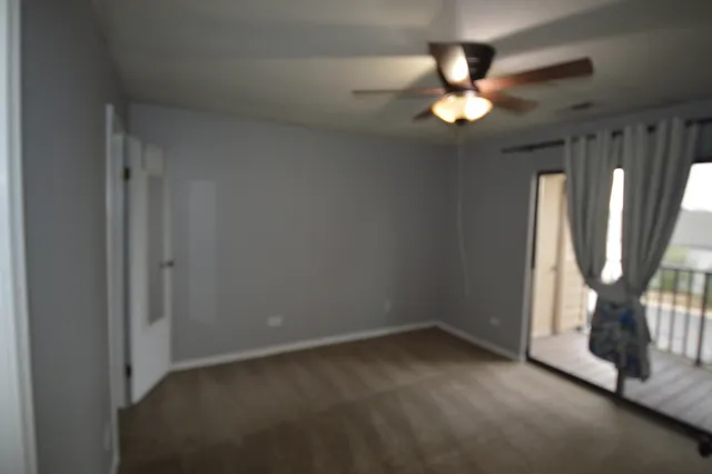 a view of a chandelier in big room and chandelier fan