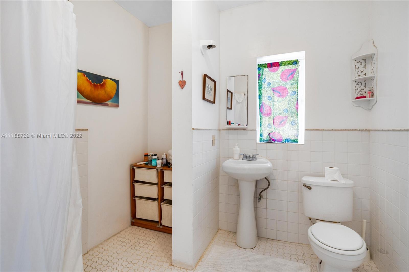 635 Northeast 68th Street Miami, FL 33138 - Photo 12 of 14 a bathroom with a toilet sink and mirror