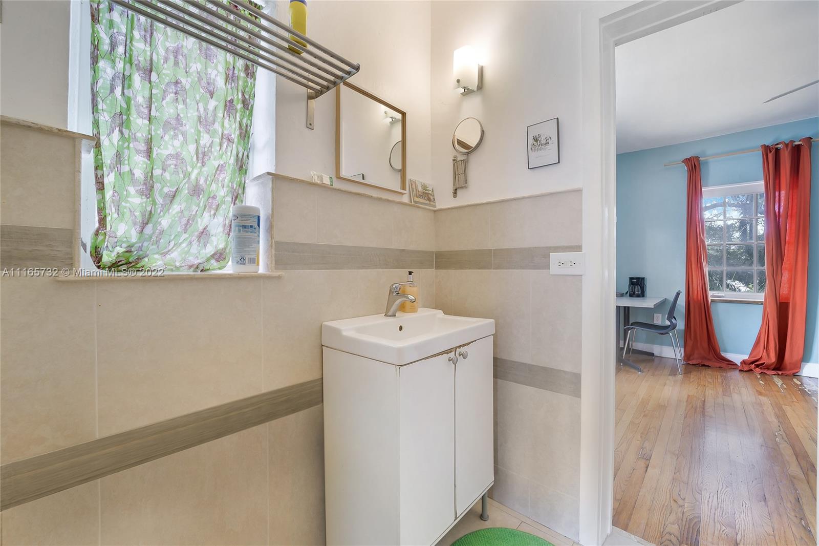 635 Northeast 68th Street Miami, FL 33138 - Photo 14 of 14 a bathroom with a sink a toilet and a window