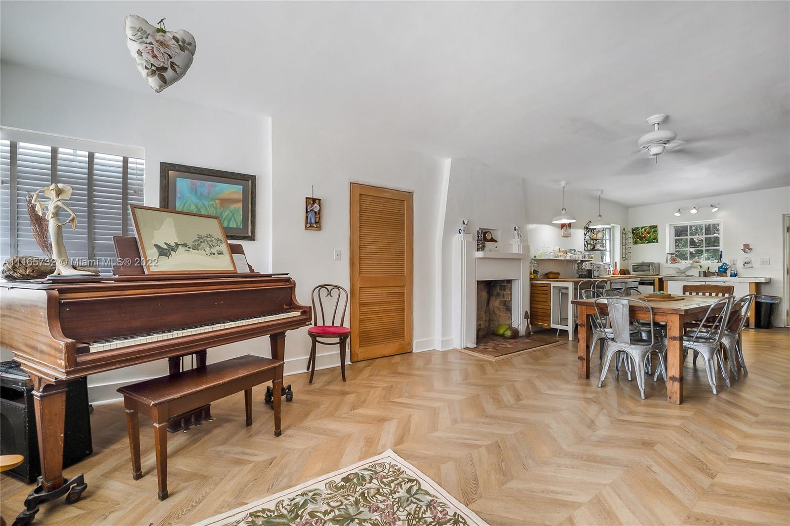 635 Northeast 68th Street Miami, FL 33138 - Photo 3 of 14 a living room with furniture a piano and a fireplace