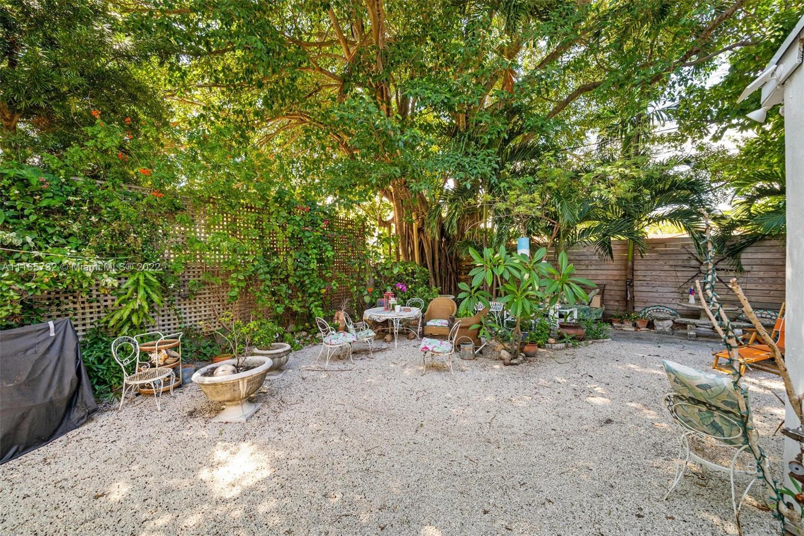 635 Northeast 68th Street Miami, FL 33138 - Photo 6 of 14 a backyard of a house with table and chairs