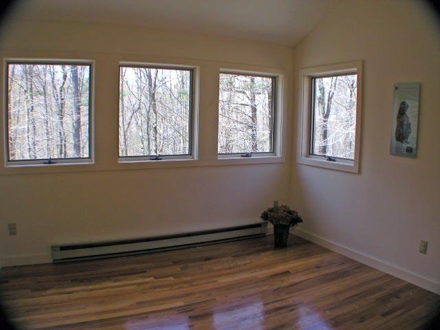 474 Norton Road Otis, MA 01029 - Photo 13 of 16 a view of an empty room with wooden floor and a window