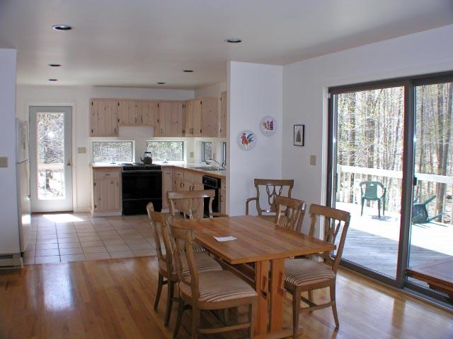 474 Norton Road Otis, MA 01029 - Photo 5 of 16 a view of a dining room with furniture and wooden floor