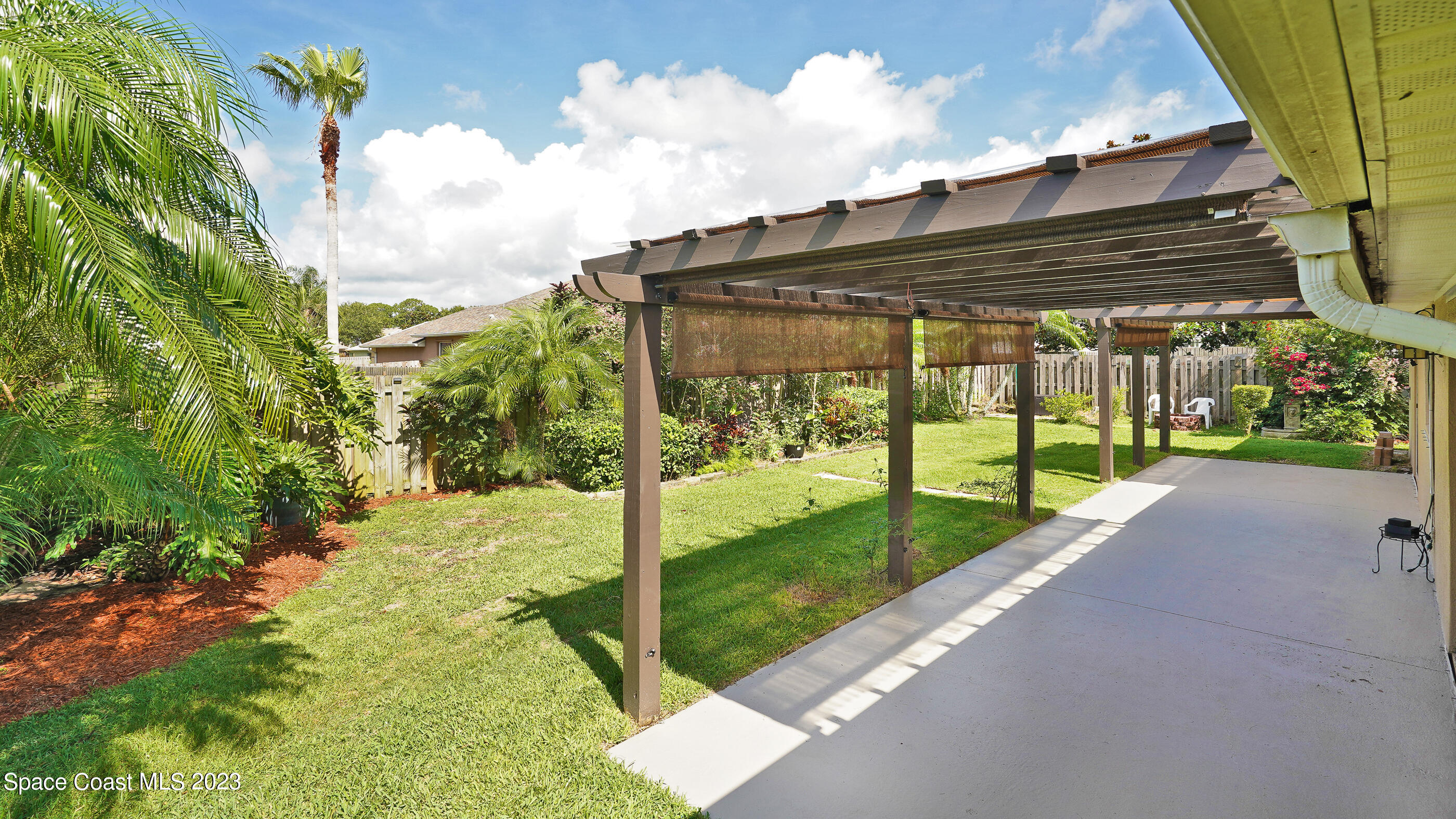 395 Brookcrest Circle Rockledge, FL 32955 - Photo 16 of 44 a view of a backyard with pathway