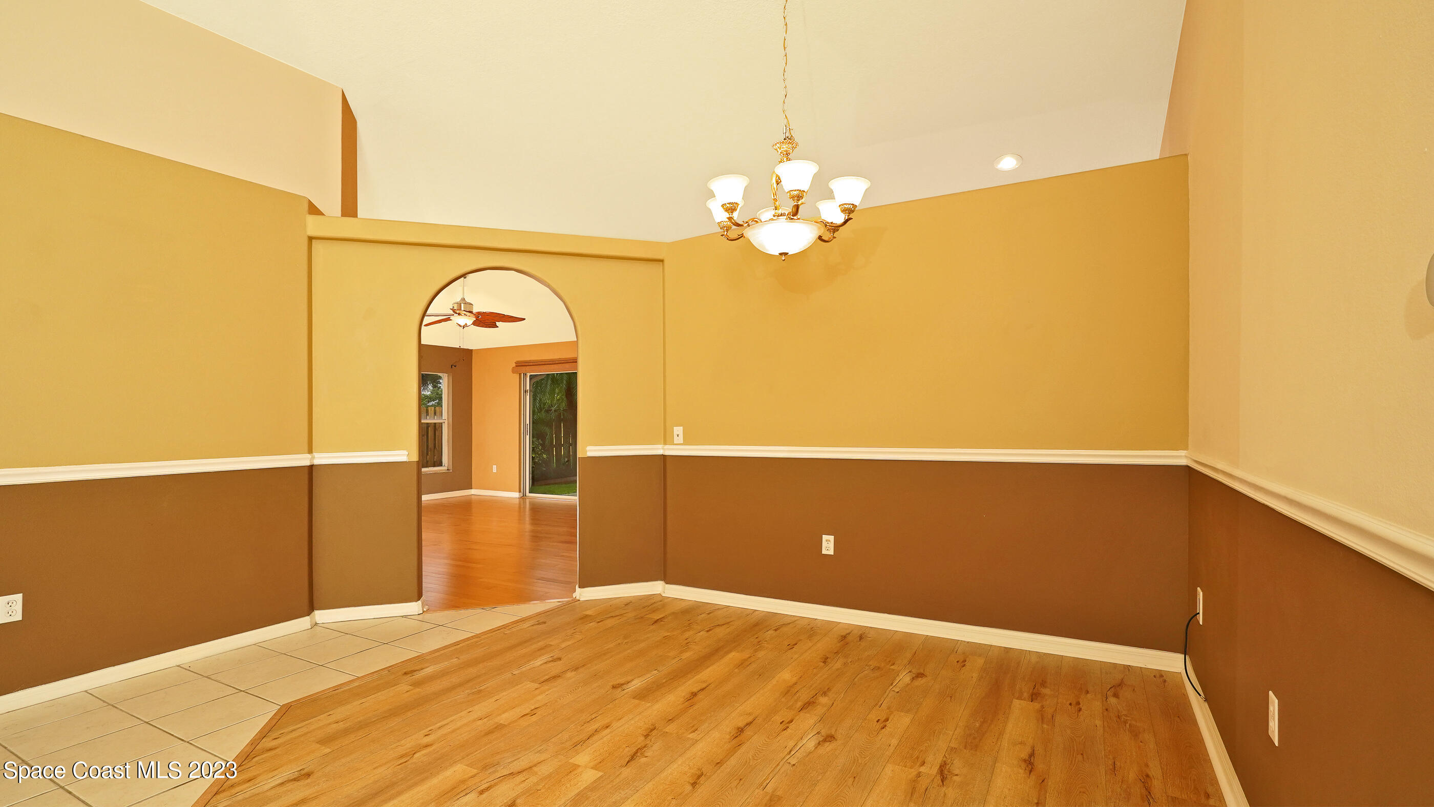 395 Brookcrest Circle Rockledge, FL 32955 - Photo 22 of 44 a bedroom with a bed and a chandelier