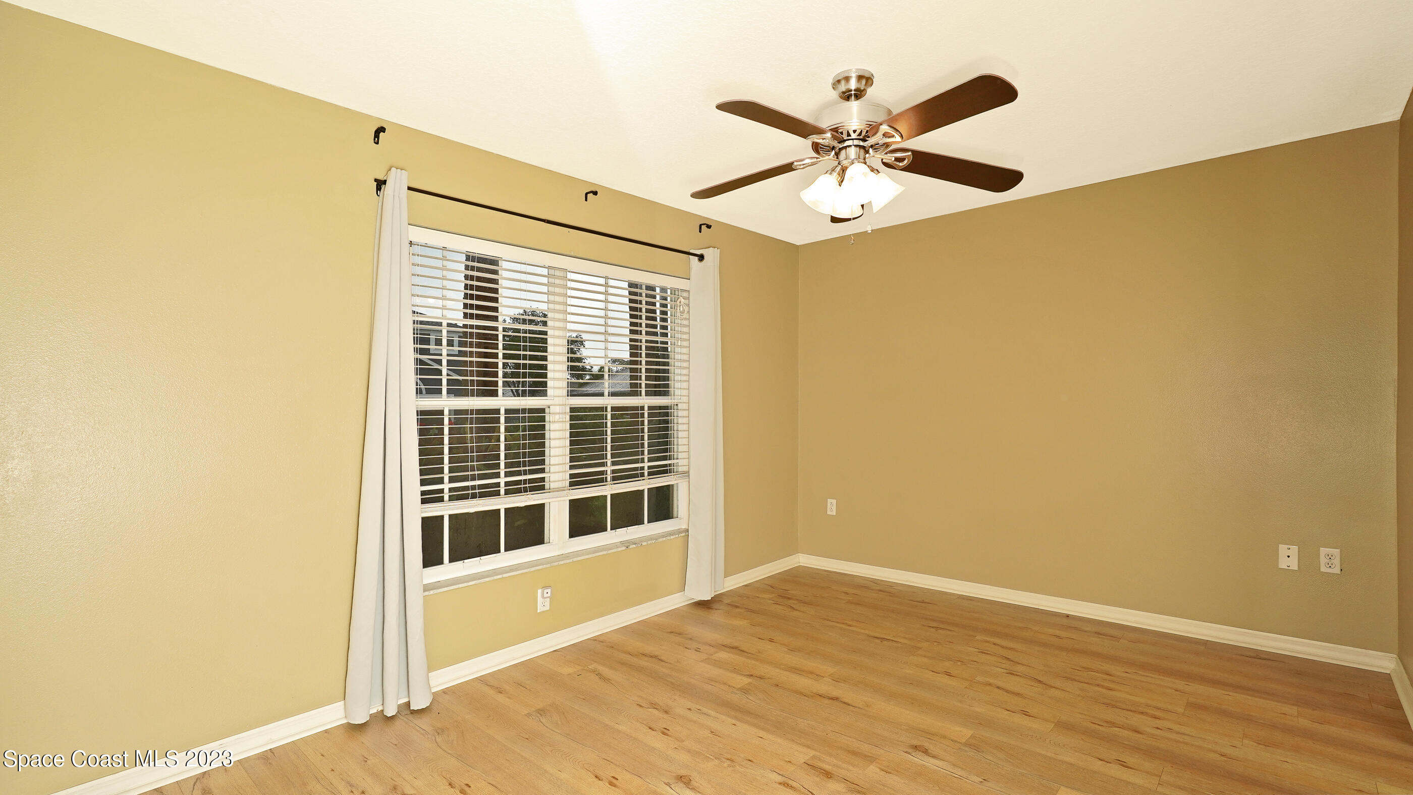 395 Brookcrest Circle Rockledge, FL 32955 - Photo 24 of 44 a view of a livingroom with a ceiling fan and wooden floor