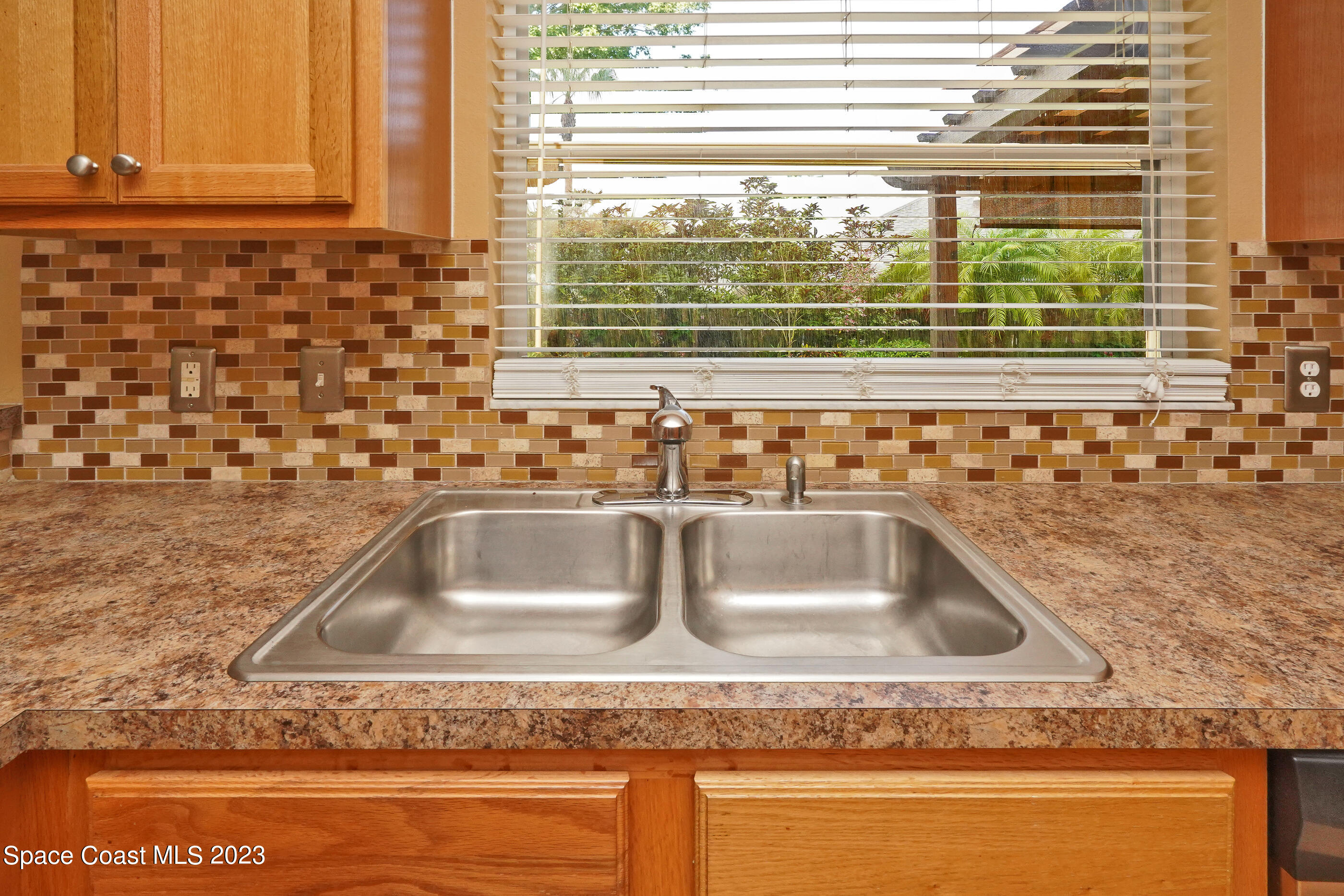 395 Brookcrest Circle Rockledge, FL 32955 - Photo 32 of 44 a kitchen sink with a granite countertop window and a sink