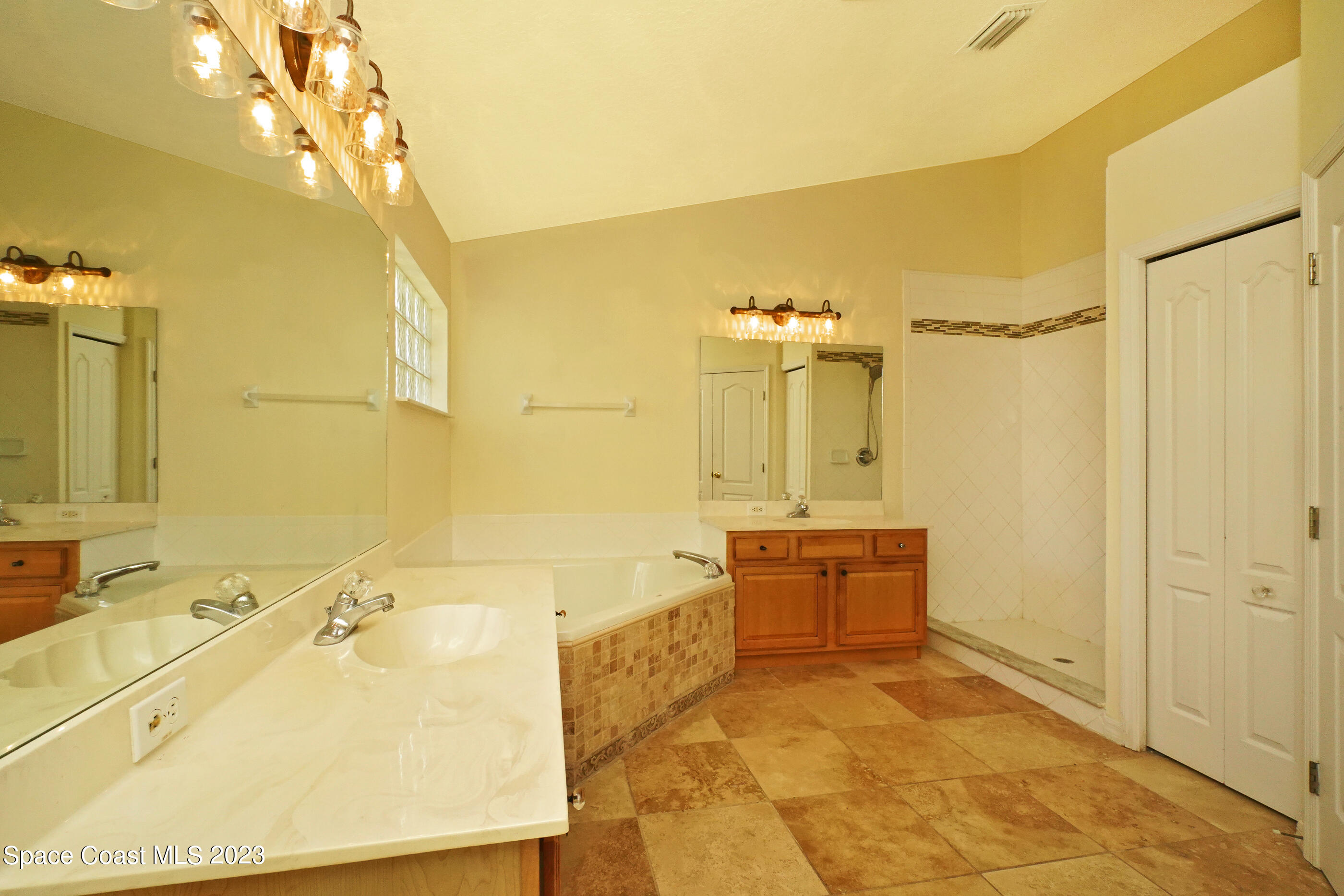 395 Brookcrest Circle Rockledge, FL 32955 - Photo 36 of 44 a bathroom with a tub sink and mirror