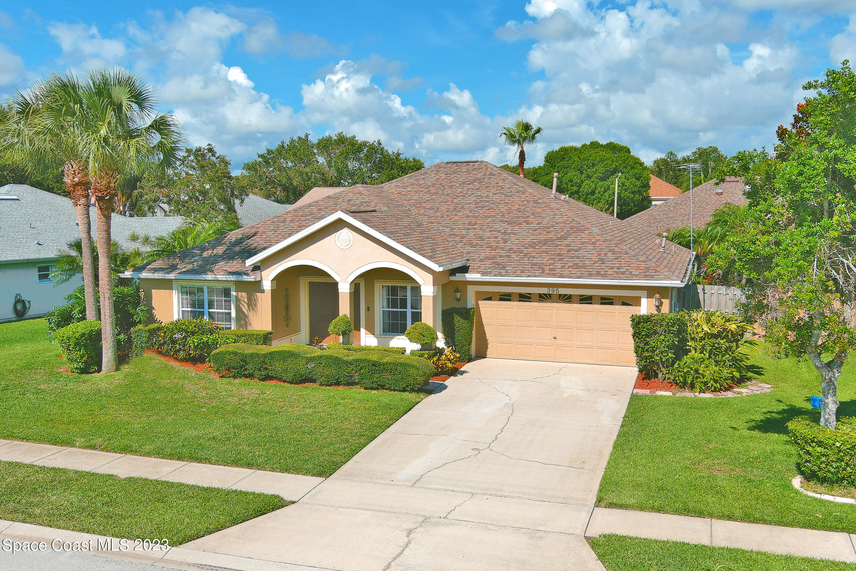 395 Brookcrest Circle Rockledge, FL 32955 - Photo 4 of 44 a view of house with garden and tall trees