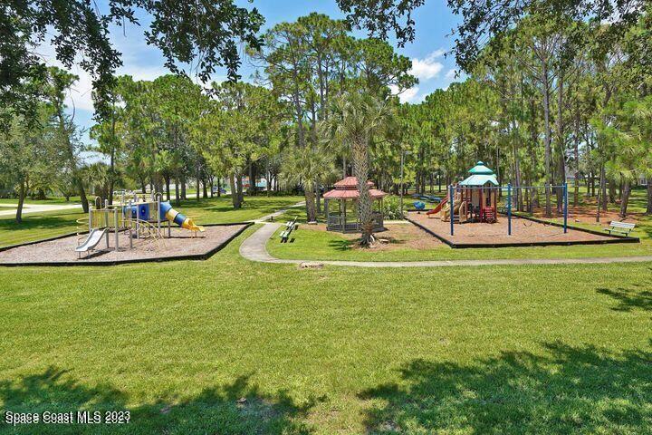 395 Brookcrest Circle Rockledge, FL 32955 - Photo 42 of 44 a view of a park with swings and slides