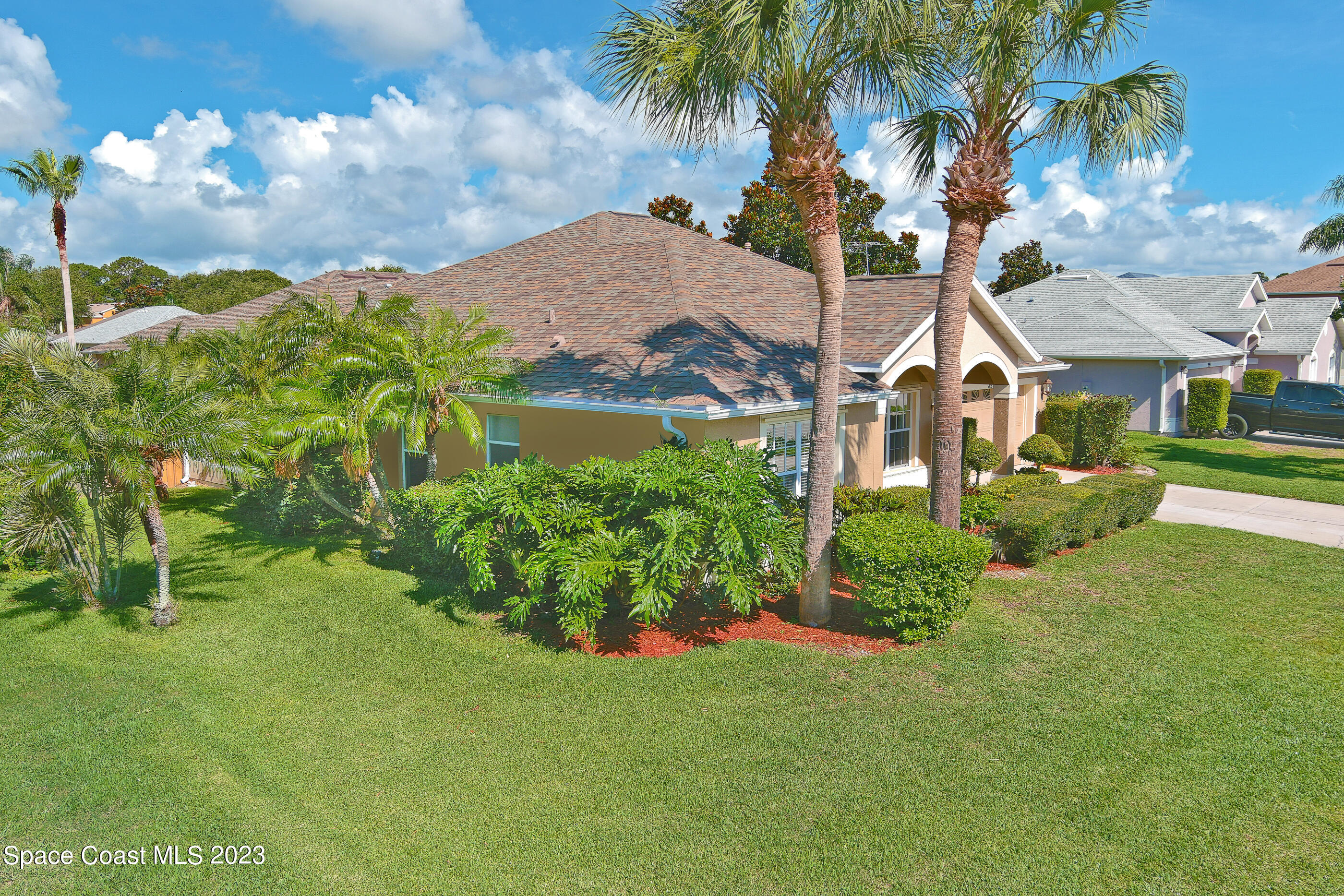 395 Brookcrest Circle Rockledge, FL 32955 - Photo 7 of 44 a view of a garden with a building in the background