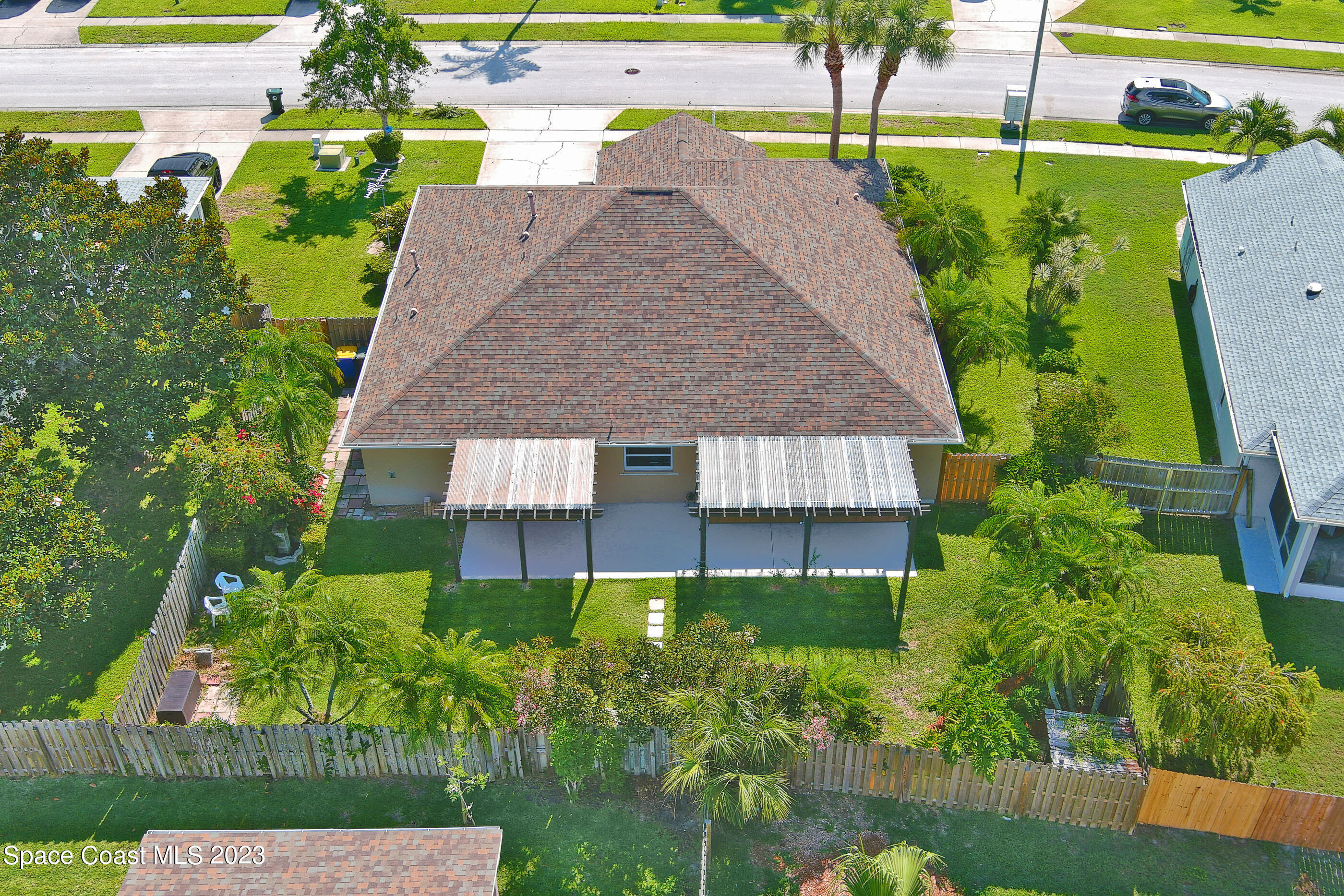 395 Brookcrest Circle Rockledge, FL 32955 - Photo 9 of 44 a aerial view of a house with a yard and plants