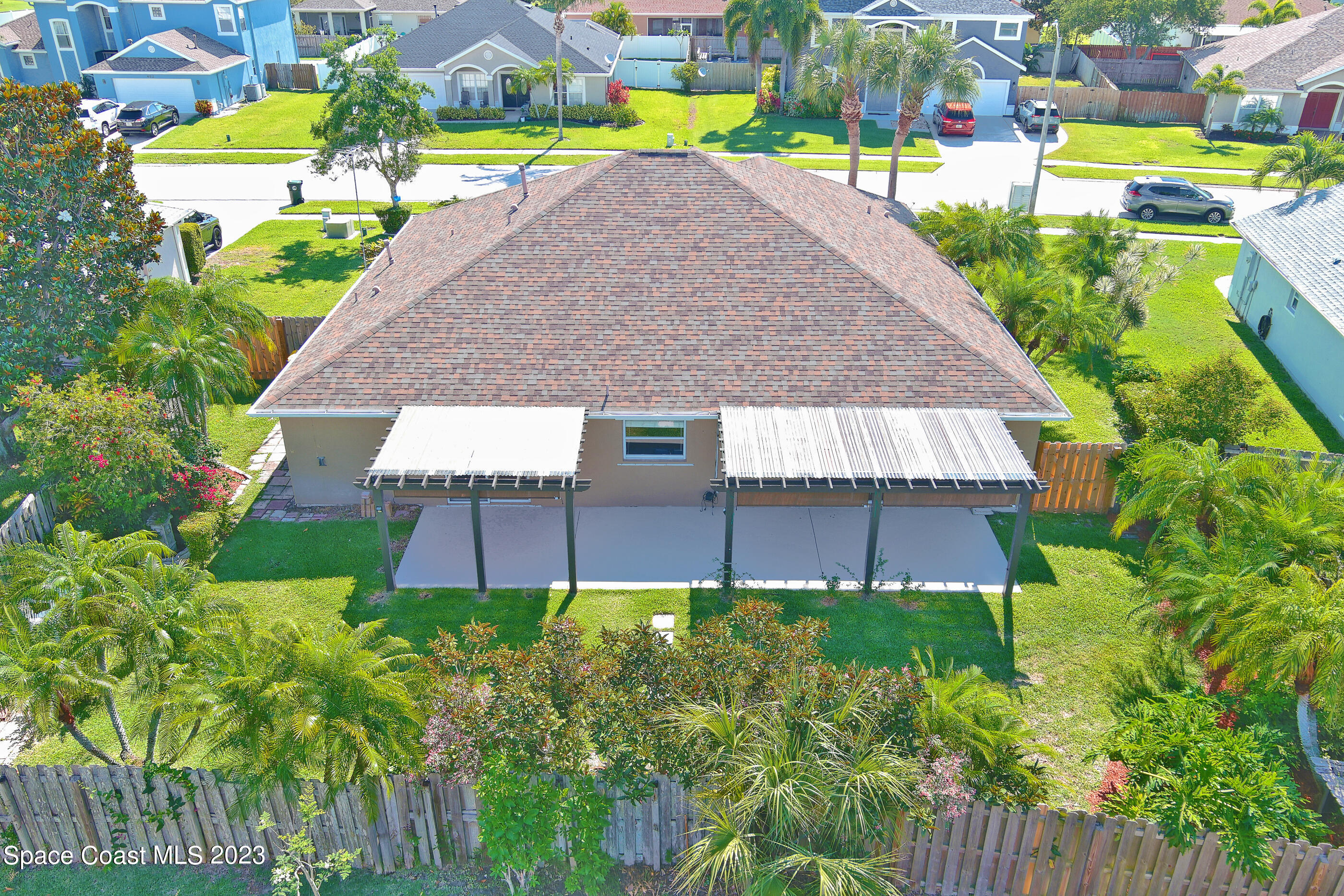 395 Brookcrest Circle Rockledge, FL 32955 - Photo 10 of 44 a view of a house with a big yard plants and large trees