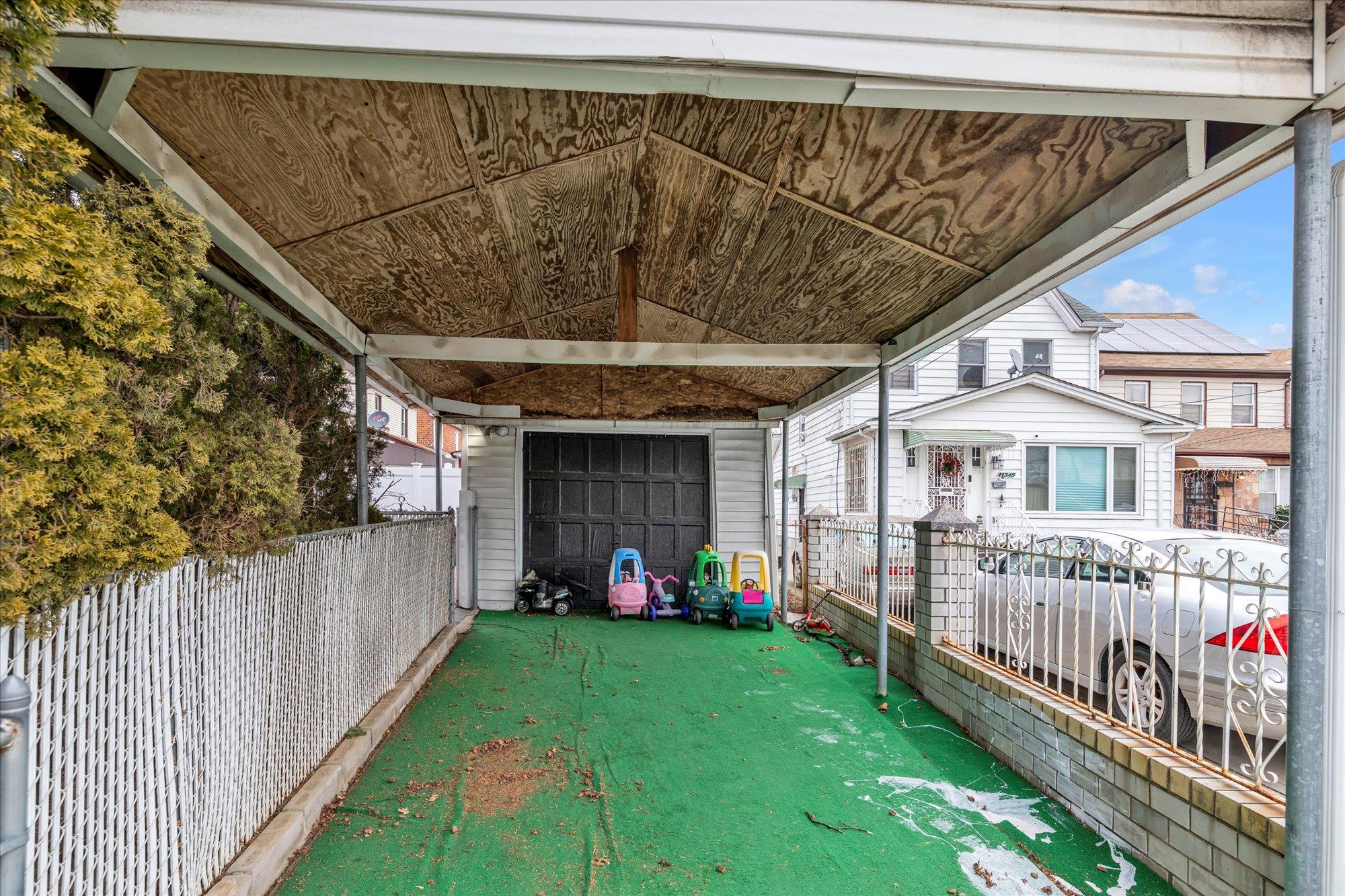 113-07 Colfax Street Queens, NY 11429 - Photo 17 of 17 a view of a porch with a small yard