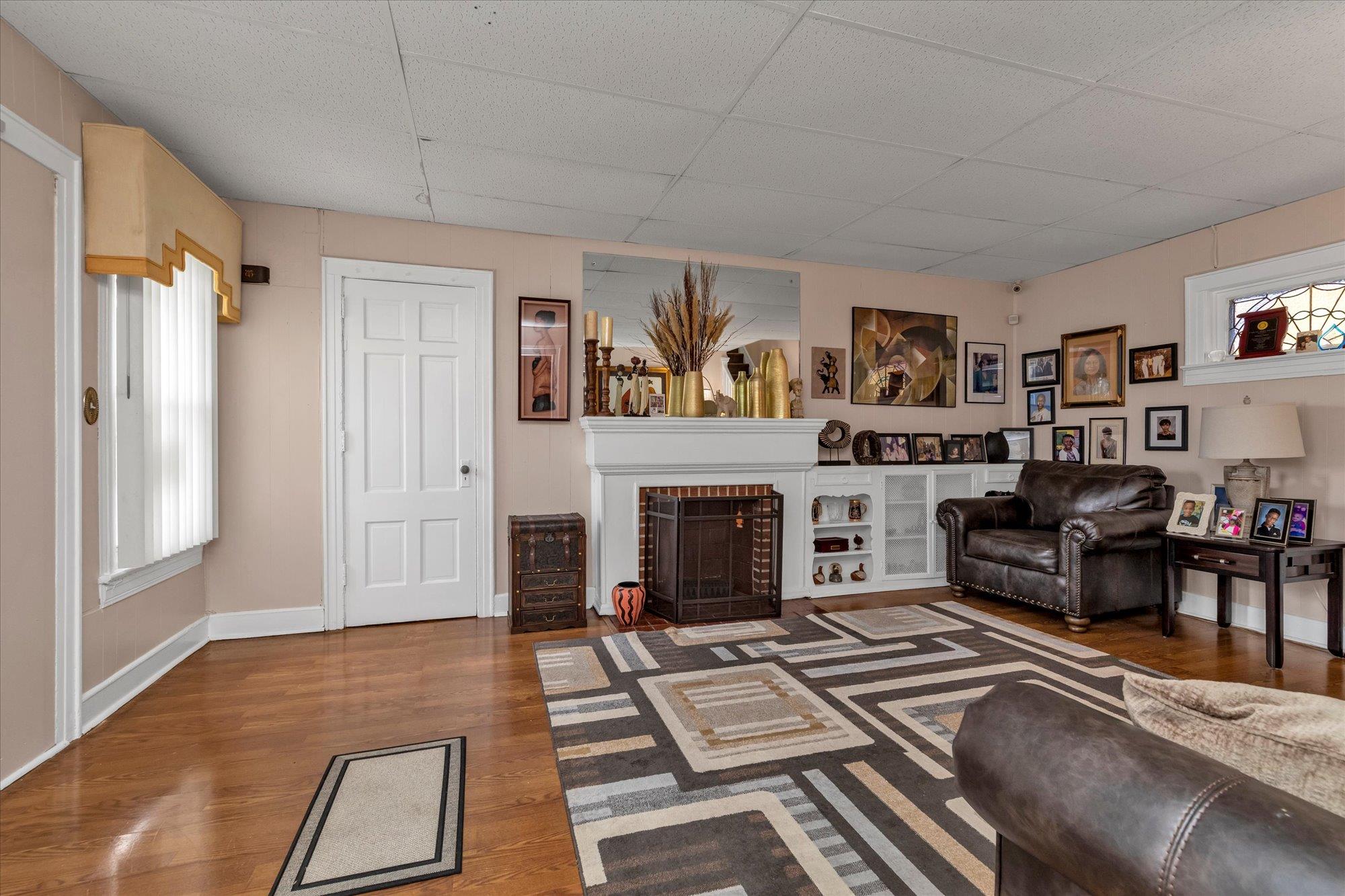 113-07 Colfax Street Queens, NY 11429 - Photo 4 of 17 a living room with furniture and a fireplace