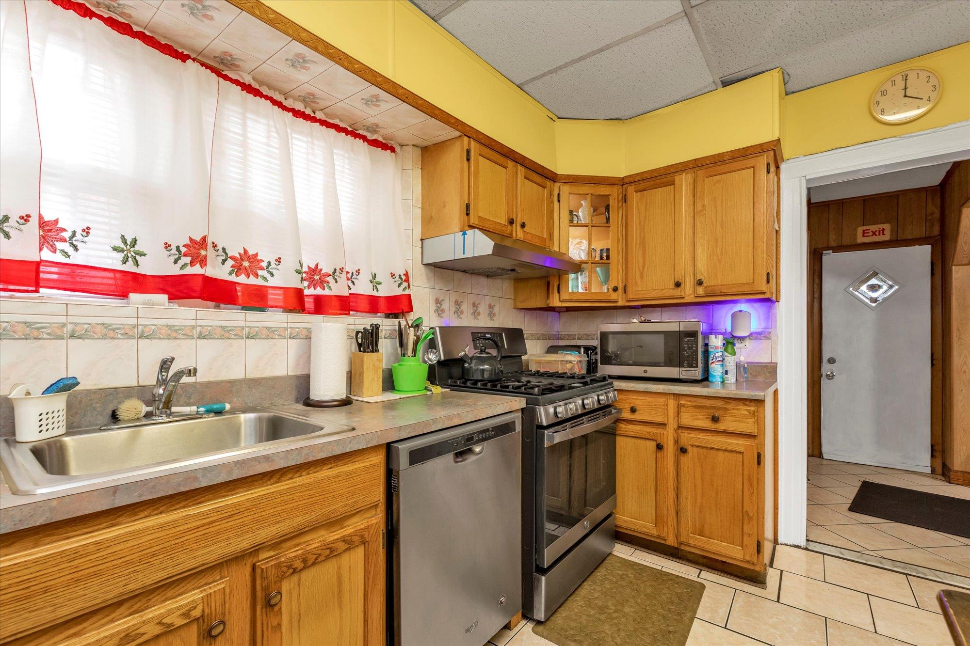113-07 Colfax Street Queens, NY 11429 - Photo 6 of 17 a kitchen with stainless steel appliances granite countertop a sink and cabinets