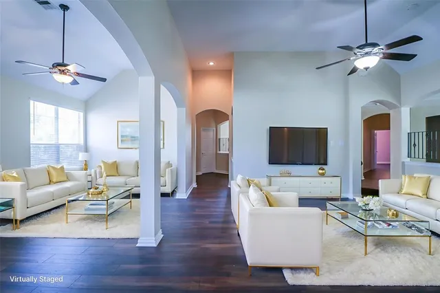 a spacious bedroom with a bed and a flat screen tv