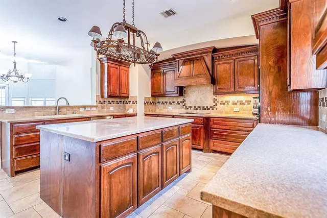a kitchen with a sink a counter space and a window