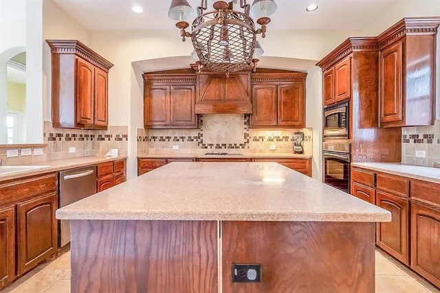 a kitchen with stainless steel appliances granite countertop a sink and cabinets