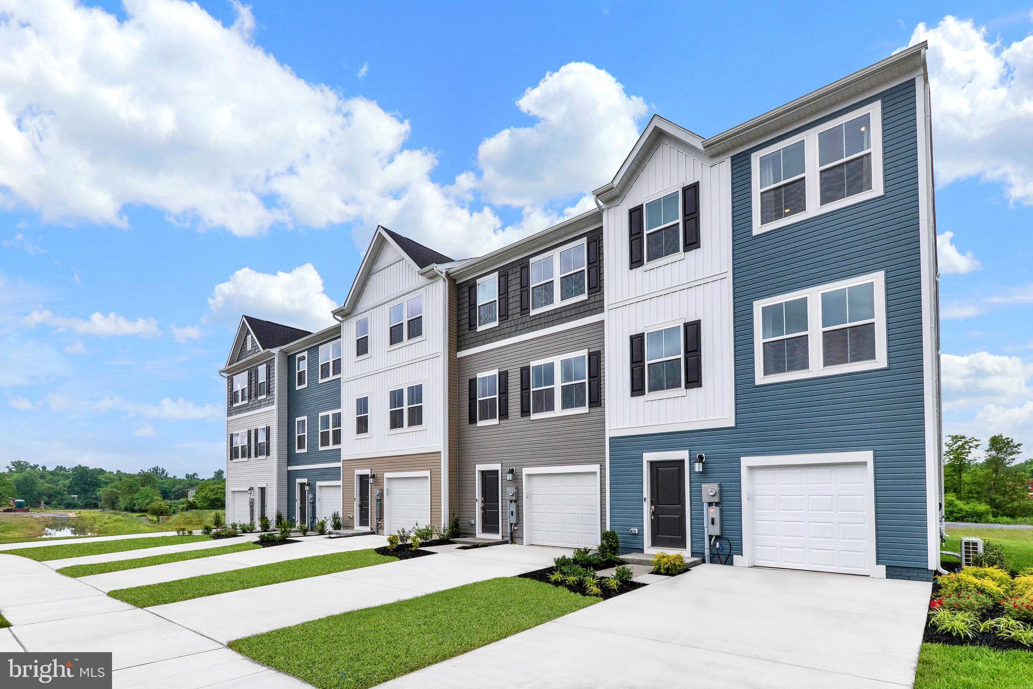 a front view of a building with a garden and plants