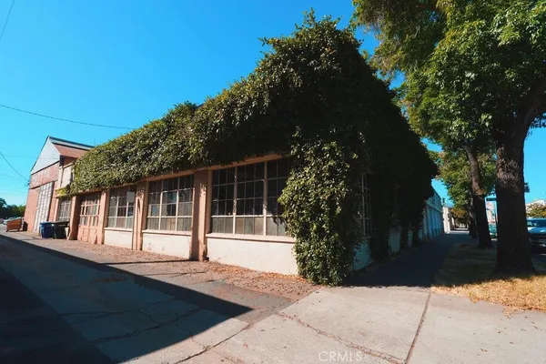 a view of house with backyard space and garden