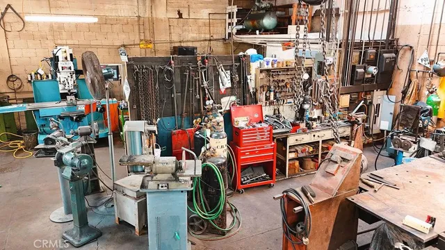 a view of a workspace with furniture and floor to ceiling window