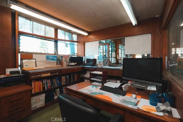 a room with furniture pool table and large windows