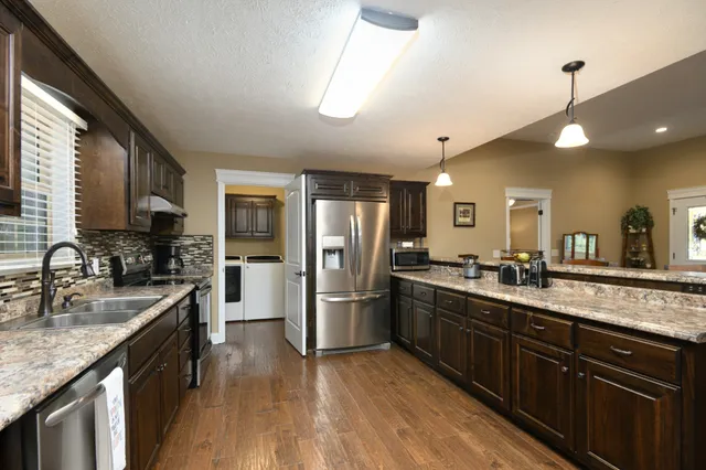 a kitchen with lots of counter top space and dining table