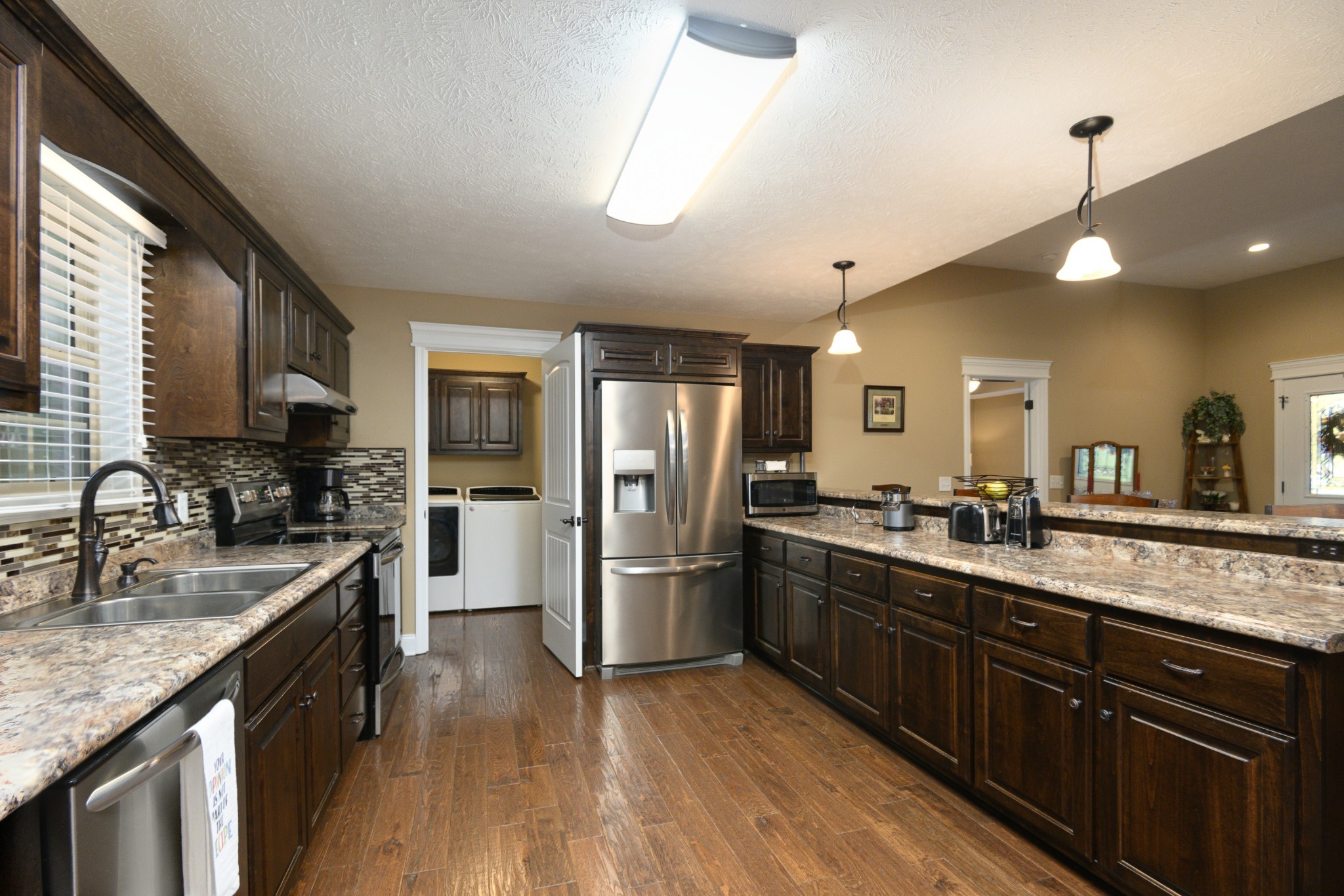 255 Troupe Road Shelbyville, TN 37160 - Photo 11 of 68 a kitchen with stainless steel appliances granite countertop a sink a stove and refrigerator