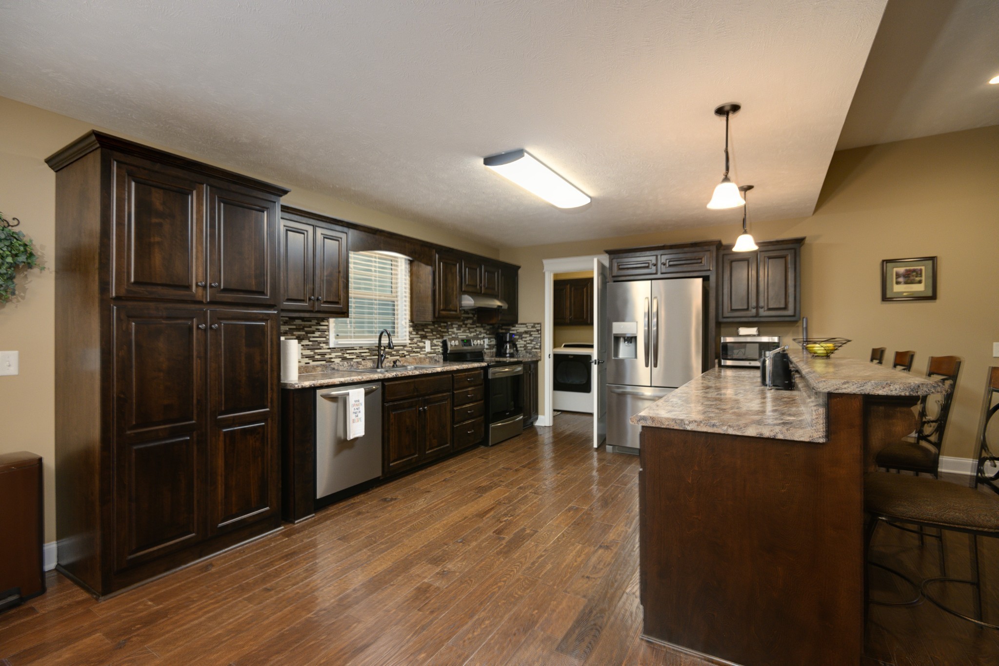 255 Troupe Road Shelbyville, TN 37160 - Photo 14 of 68 a kitchen with kitchen island granite countertop stainless steel appliances and refrigerator