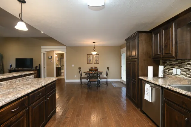 a living room with furniture and view of kitchen