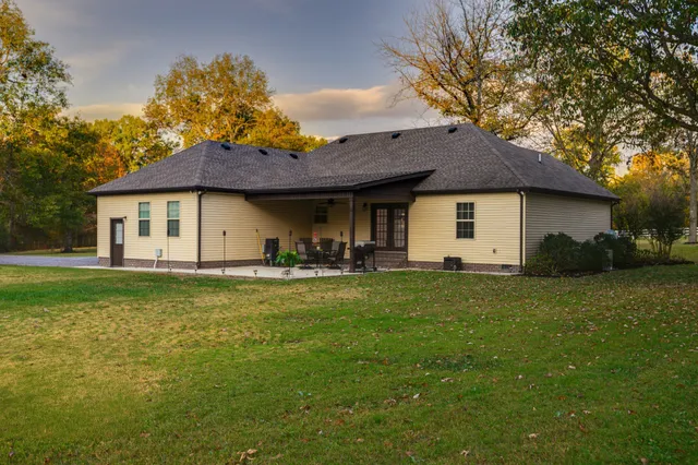 a front view of house with a garden