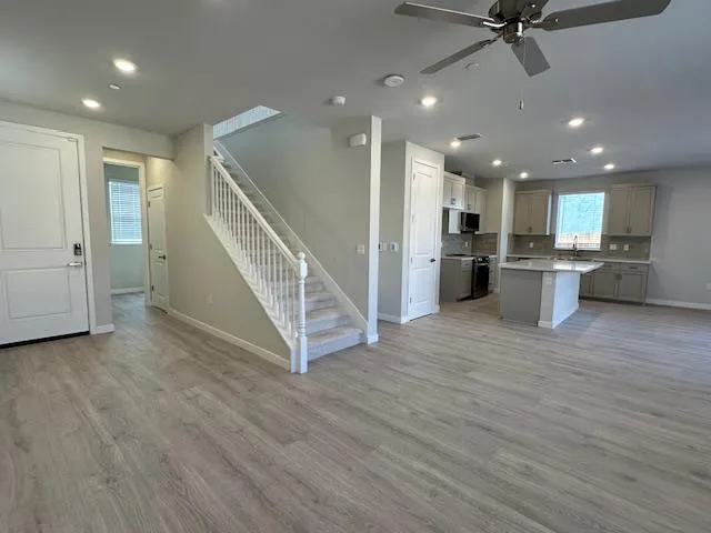 a view of a kitchen with furniture and a wooden floor