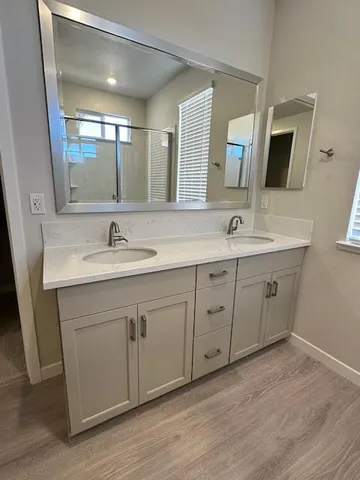 a spacious bathroom with a double vanity sink and mirror