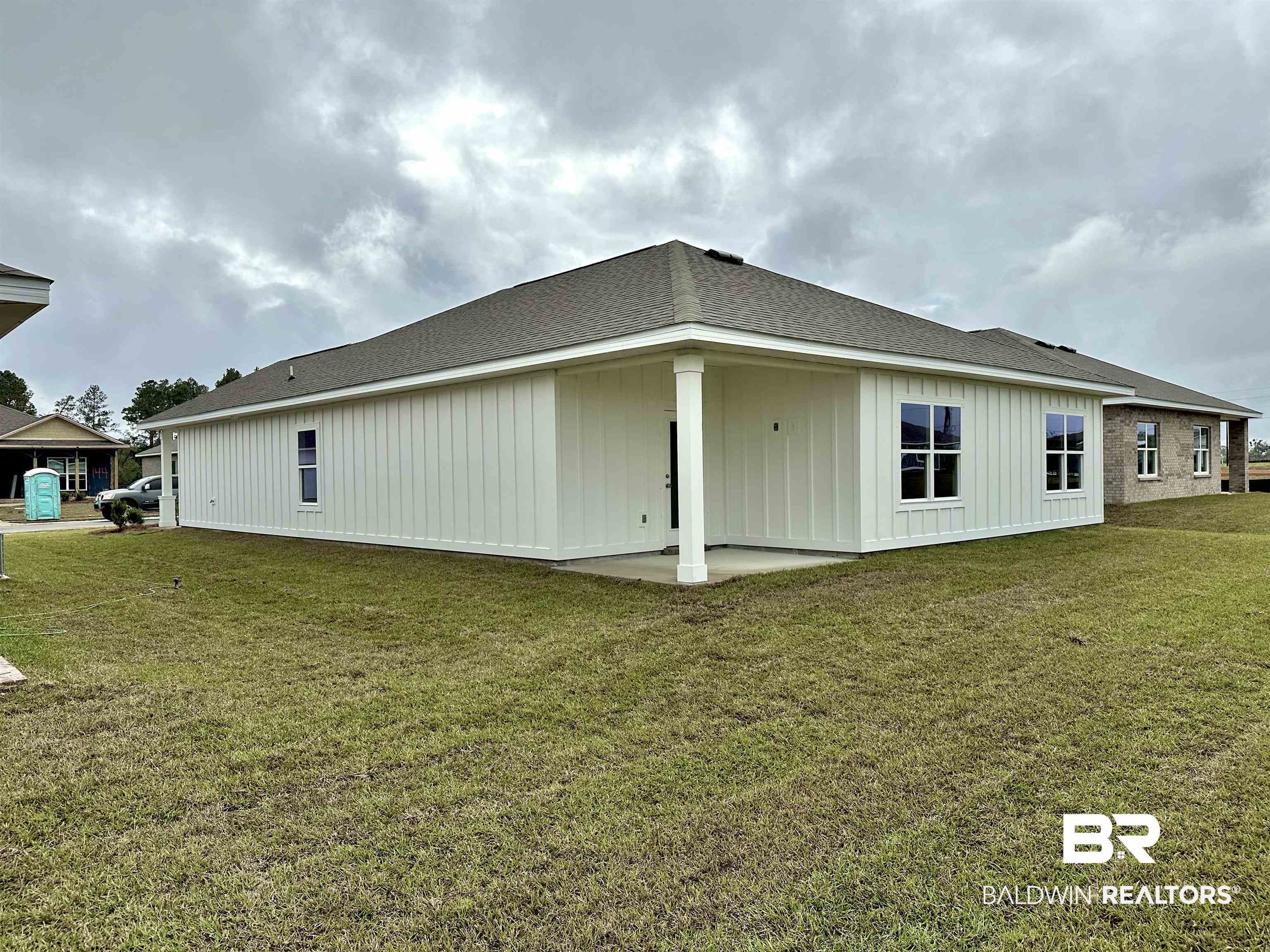 1252 Hayward Loop Foley, AL 36535 - Photo 5 of 44 View of property exterior featuring a patio area and a yard
