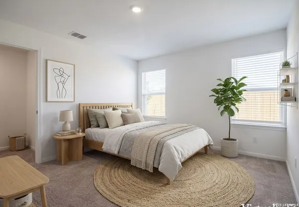 a bedroom with a bed and a potted plant