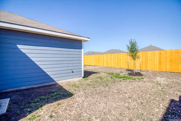 a view of a backyard of the house