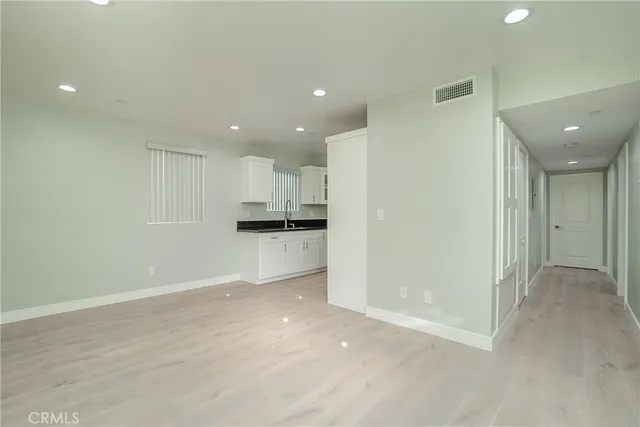 a view of kitchen with refrigerator and window