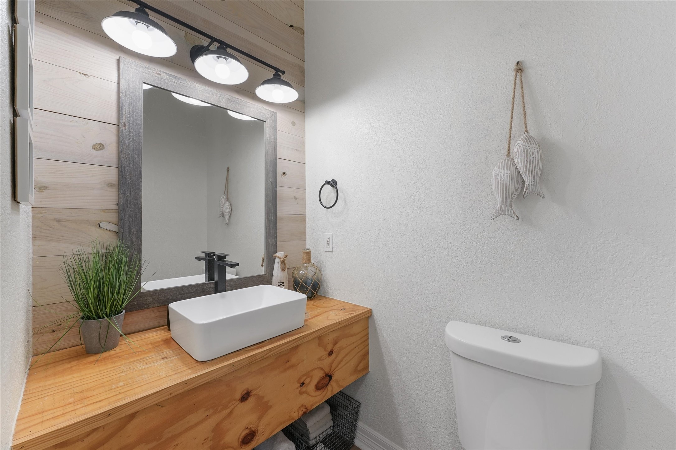 3024 Avenue R 1/2 Galveston, TX 77550 - Photo 18 of 28 a bathroom with a sink a toilet and mirror
