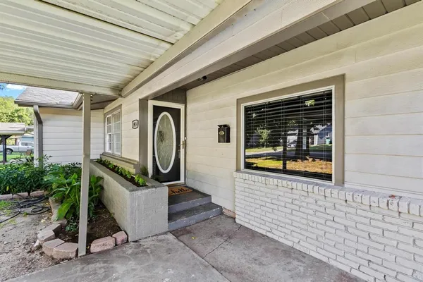 a kitchen with stainless steel appliances a stove top oven a sink a refrigerator white cabinets and wooden floor