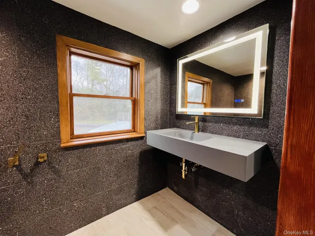 a bathroom with a sink and a mirror