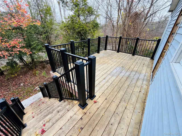 a view of balcony with wooden floor and fence